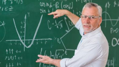 1655391370 senior teacher glasses explaining math example green chalkboard 1